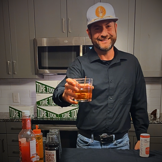 Bartender serving non-alcoholic, THC-infused Old Fashioned cocktail
